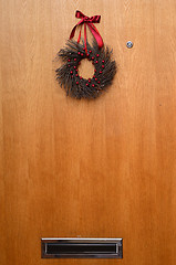 Image showing wooden door with a Christmas wreath and mailbox