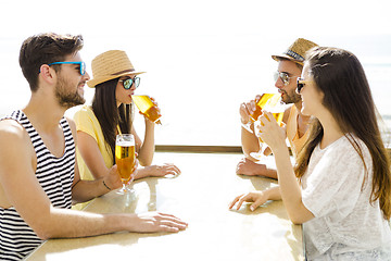 Image showing Friends drinking a cold beer