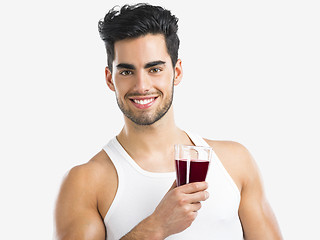 Image showing Athletic man drinking a juice