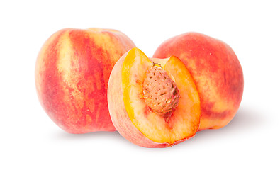 Image showing Two whole and half of peach