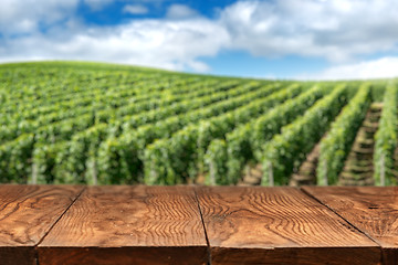 Image showing wooden table with vineyard landscape