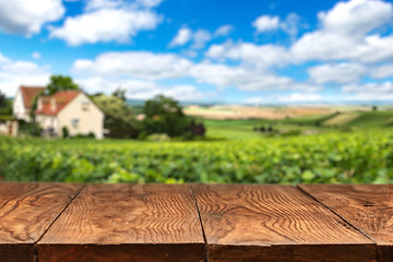 Image showing wooden table with vineyard landscape