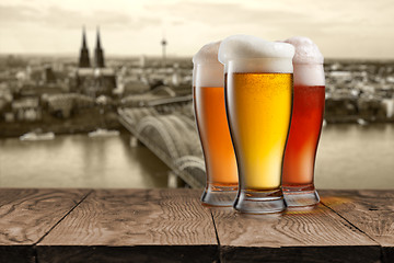 Image showing Glass of beer with view of Koeln on background