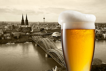 Image showing Glass of beer with view of Koeln on background