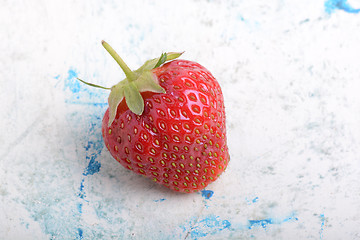 Image showing Close-up detail of a fresh red strawberry with leaves