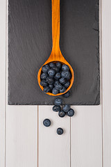 Image showing Blueberries on a wooden spoon