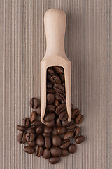 Image showing Wooden scoop with coffee beans