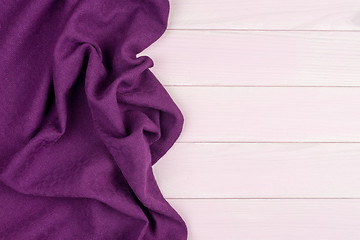 Image showing Purple towel over wooden table