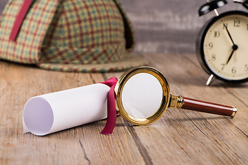 Image showing Wrapped paper sheets and magnifying glass