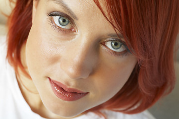 Image showing beautician is doing make-up to red-haired woman