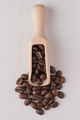Image showing Wooden scoop with coffee beans