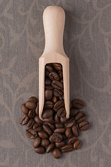 Image showing Wooden scoop with coffee beans