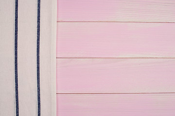 Image showing White and blue towel over wooden table