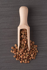 Image showing Wooden scoop with lentils