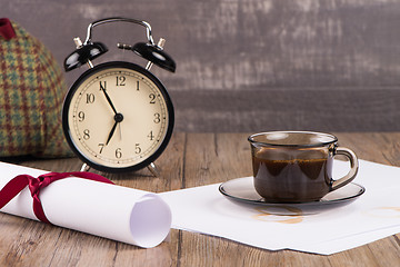 Image showing Old clock, hat, coffee and paper sheets