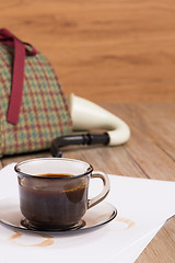 Image showing Coffee cup, paper sheets and detective hat