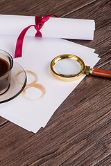 Image showing Wrapped paper sheets and magnifying glass