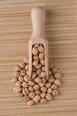 Image showing Wooden scoop with chickpeas