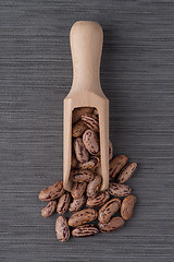 Image showing Wooden scoop with pinto beans