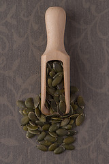 Image showing Wooden scoop with pumpkin seeds