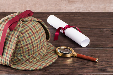 Image showing Wrapped paper sheets and magnifying glass