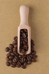 Image showing Wooden scoop with coffee beans