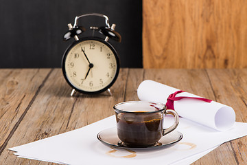 Image showing Old clock, hat, coffee and paper sheets