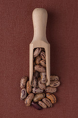 Image showing Wooden scoop with pinto beans