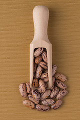 Image showing Wooden scoop with pinto beans