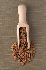 Image showing Wooden scoop with lentils