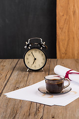 Image showing Old clock, hat, coffee and paper sheets