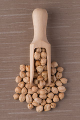 Image showing Wooden scoop with chickpeas