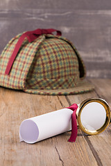 Image showing Wrapped paper sheets and magnifying glass