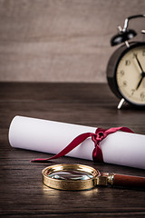 Image showing Wrapped paper sheets and magnifying glass