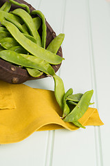 Image showing Snow peas on wooden bowl