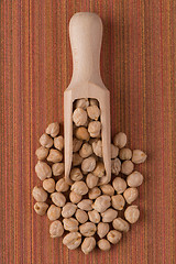 Image showing Wooden scoop with chickpeas