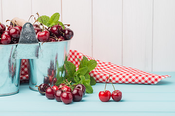 Image showing Cherries in two small metal buckets