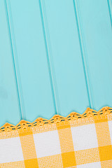 Image showing White and yellow towel over wooden table