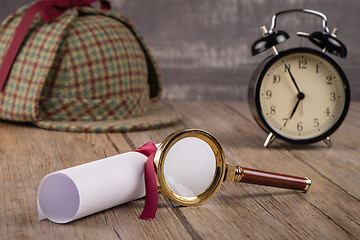 Image showing Wrapped paper sheets and magnifying glass