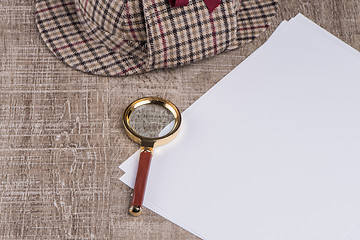 Image showing Paper sheets and magnifying glass