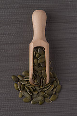 Image showing Wooden scoop with pumpkin seeds