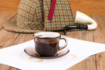 Image showing Coffee cup, paper sheets and detective hat