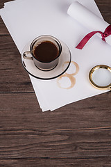 Image showing Coffee cup, paper sheets and detective hat