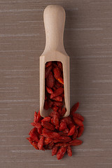 Image showing Wooden scoop with dry red goji berries