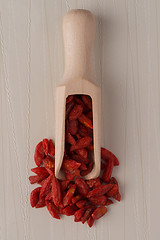 Image showing Wooden scoop with dry red goji berries