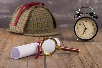 Image showing Wrapped paper sheets and magnifying glass