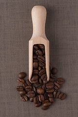 Image showing Wooden scoop with coffee beans