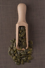 Image showing Wooden scoop with pumpkin seeds