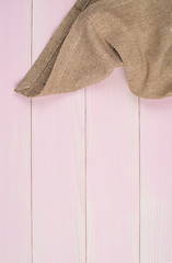 Image showing Beige towel over wooden table