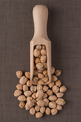 Image showing Wooden scoop with chickpeas